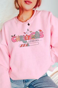 a woman wearing a pink christmas sweatshirt and jeans
