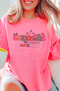 a woman wearing a pink christmas loading sweatshirt