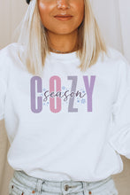 Load image into Gallery viewer, a woman wearing a white sweatshirt with the word cozy on it
