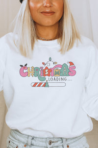 a woman wearing a white christmas sweatshirt with the words christmas loading on it